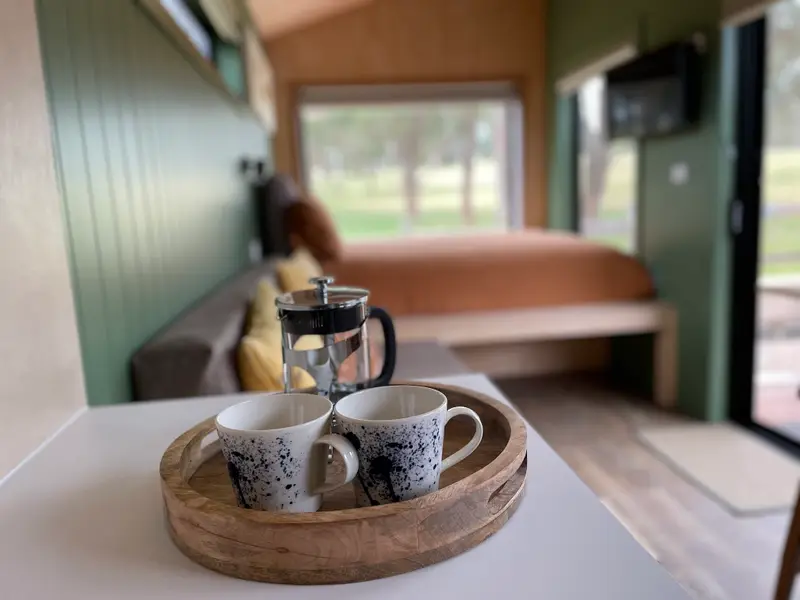 Coffee plunger and mugs on a timber tray