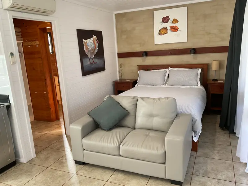 Deluxe 3 main room with queen bed and sofa
